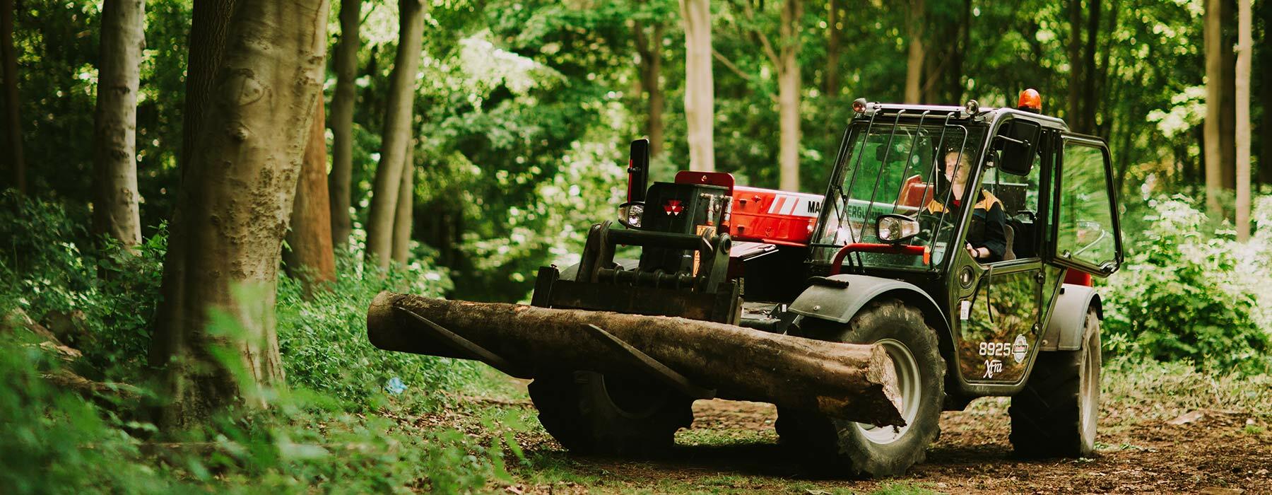Student operating fork lift in woodland